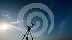 Time-lapse. A man shooting the night sky with a tripod