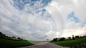 Time lapse motion The wooden bridge and The reflection of the Sun with the  clouds move fast on the sky in paddy fields