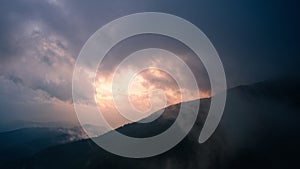 Time-lapse of mountain nature with misty clouds fast movement. Beautiful Landscape in the morning during sunrise with fog over the