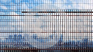 Time lapse moving clouds reflected building façade.