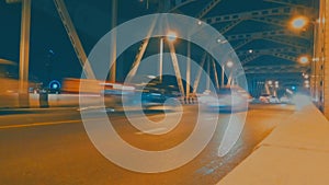 Time lapse of night light traffic fast moving car on Krungthep metal Bridge drawbridge, Bangkok, Thailand slow shutter speed, long