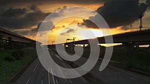 Time lapse of night shot - freeway and car light trails at sunset