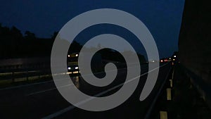 Time lapse of night traffic on the highway. Busy traffic on the night highway. Trucks driving on the highway.