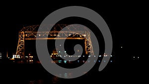 Time lapse at night of two ships going under Duluth aerial lift bridge