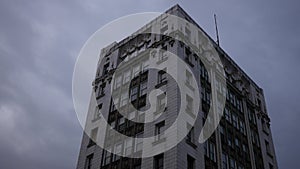 Time-lapse of old creepy skyscraper Victorian building near evening