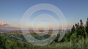 Time Lapse panorama view of a mountain landscape during sunset with clouds moving over the hills and moving to the right