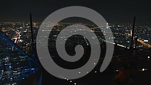 Time lapse of people on King Power Mahanakhon building rooftop at night