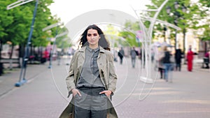 Time lapse portrait of young brunette standing in the street alone among crowd