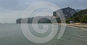 Time lapse of rain clouds over beach and sea landscape with boats. Tropical storm in ocean.