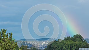 Time lapse, Rainbow in the sky. Rainbow forming from sun and rain storm on mountain hills. Switzerland