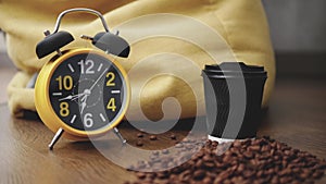 Time lapse.Retro clock with alarm clock,running arrow on the clock,showing 7 o`clock on the hands of the clock.A glass of coffee w