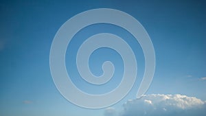 Time-lapse rolling clouds, clouds running across brilliant blue sky, cumulus cloud form against a dark blue sky