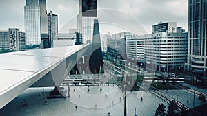 Time-lapse of Rotterdam station with skyscrapers. Pedestrians, cars and trams.