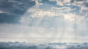 Time-lapse scene of cloudy sky with ray of sun light over city