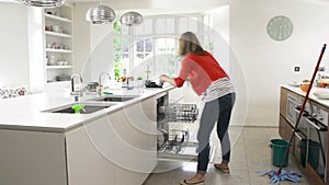 Time Lapse Sequence Of Busy Woman Working In Kitchen