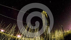 Time lapse of shooting stars over fence