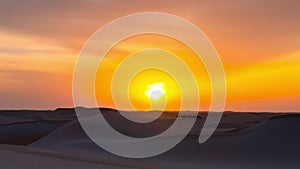 Time lapse of sky clouds sunset sunrise over the sand dune desert, camels walking with owner.