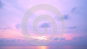 Time-lapse of smooth colorful clouds at sunset or sunrise evening sky over sea wave Amazing nature video background