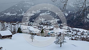 Time lapse, Snow storm coming to the town in the mountains. Alpine town covered with snow. Filzbach, canton of Glarus, Switzerland