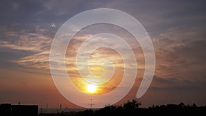 Time Lapse of Sun Rising over Moving Clouds in Orange Mist at Dawn