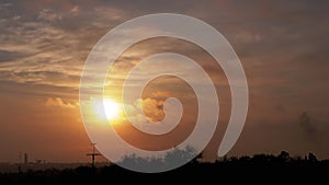 Time Lapse of Sun Rising over Moving Clouds in Orange Mist at Dawn