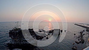 Time lapse sunset over tropical bay seen from top of mountain