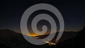 Time lapse of Susa Valley from sunset to night to sunrise, Torino Province, Italy. Mountain ridges and peaks with moving clouds, r