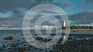 Time lapse of Swedish lighthouse on island in Oeland during sunset with dramatic moving clouds