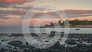 Time lapse of Swedish lighthouse on island in Oeland during sunset with dramatic moving clouds