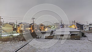 Time Lapse: Traffic speeds down residential road with snow clouds overhead