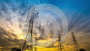 Time lapse transmission tower over sunset sky background