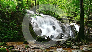 Time Lapse of tropical waterfall in deep forest, zoom in
