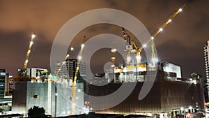 Time-lapse of under construction building site at night in the city or central business district