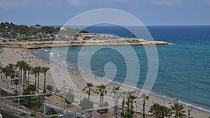 Time lapse of unidentifiable sunbathers at Miracle Beach in Tarragona, Spain on the idyllic Costa Daurada meaning Golden