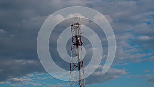 Time - lapse video telecommunication tower with moving cloud and blue sky. Time lapse footage phone tower antenna with