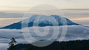 Time lapse video of white clouds over snow covered Mt St Helens in WA state 4k