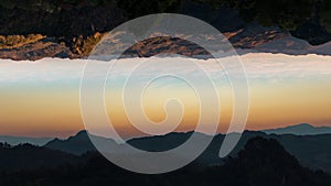 Time lapse view of colorful sunrise over mountain with Abstract upside down effect.