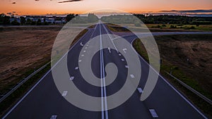 Time lapse view of the endless road going into horizon at sunset.