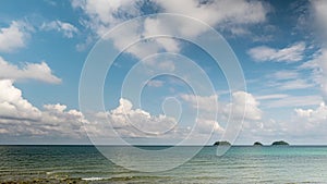 Time-lapse of viewpoint with cumulus and cirrus clouds forming above tropical islands