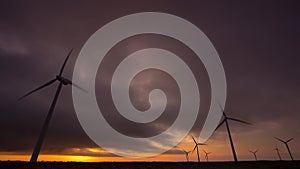 Time lapse of Wind Turbines spinning against an orange sunrise Ovenden Mooor, Halifax,