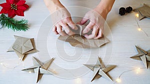 Time lapse woman hands folding origami paper star for Christmas decoration