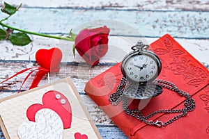 Time for love: red rose, heart, and journal with pocket watch