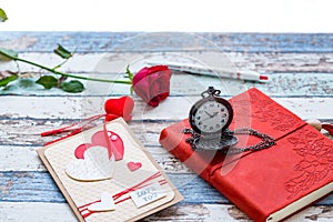 Time for love: red rose, heart, and journal with pocket watch