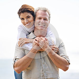 Always time for a loving moment. Portrait of a mature couple embracing lovingly while enjoying a day out in nature.