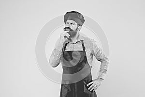 Time for lunch. thinking bearded chef. male cook in hat and apron. professional man cooking. restaurant cuisine and