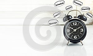 Time management business strategy concept - The black alarm clock with text graphics such as management, planning, process, alert