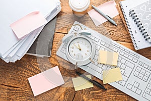 Time management concept. Composition with alarm clock on wooden table with laptop computer, stationary and post-it notes