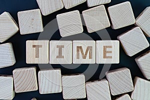 Time management, deadline, schedule and reminder concept, straggle cube wooden blocks with some combine the word Time on dark photo