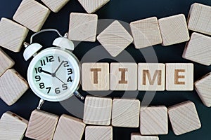 Time management, deadline, schedule and reminder concept, straggle cube wooden blocks with some combine the word Time with white photo
