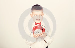 Time management. Morning. Party time. Businessman. Formal wear. tuxedo kid. Happy childhood. little boy with alarm clock